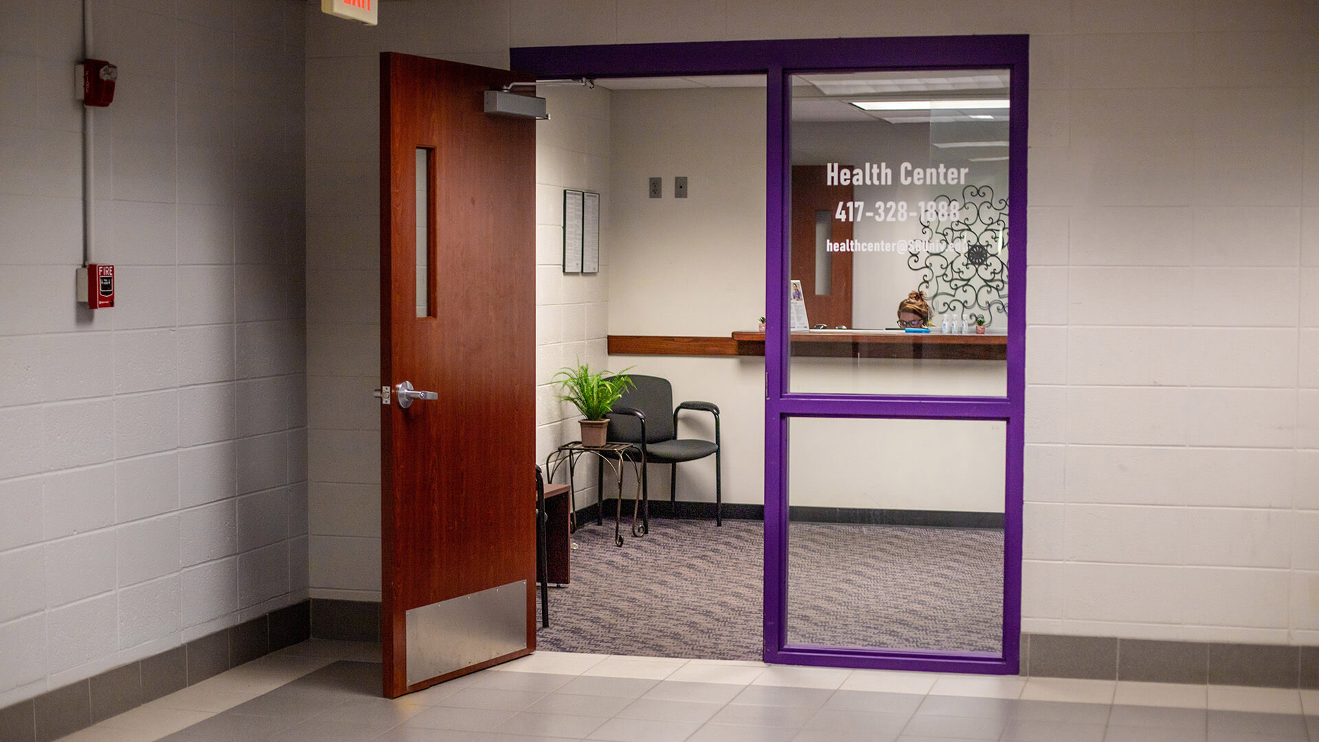 campus nurse and office assistant; front entrance view of Killian Health Center